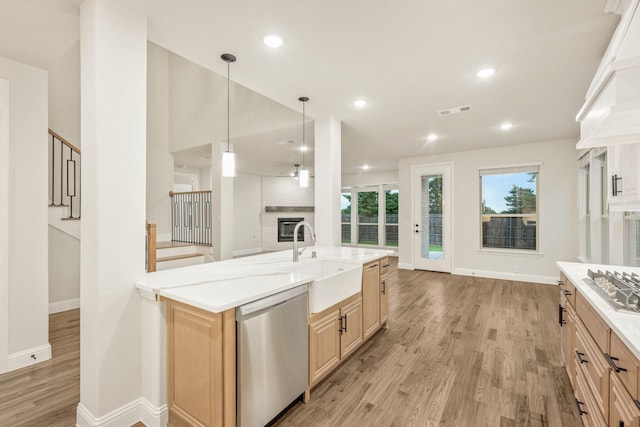 1130 Cardinal Dr, Midlothian, TX 76065 - kitchen with stainless steel appliances, a sink, light brown cabinets, light wood-style floors, and baseboards