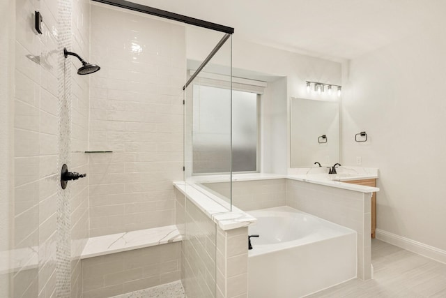 1130 Cardinal Dr, Midlothian, TX 76065 - bathroom featuring a garden tub, a tile shower, baseboards, and vanity