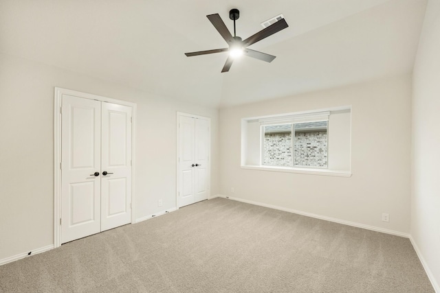 1130 Cardinal Dr, Midlothian, TX 76065 - unfurnished bedroom with two closets, carpet flooring, baseboards, lofted ceiling, and a ceiling fan