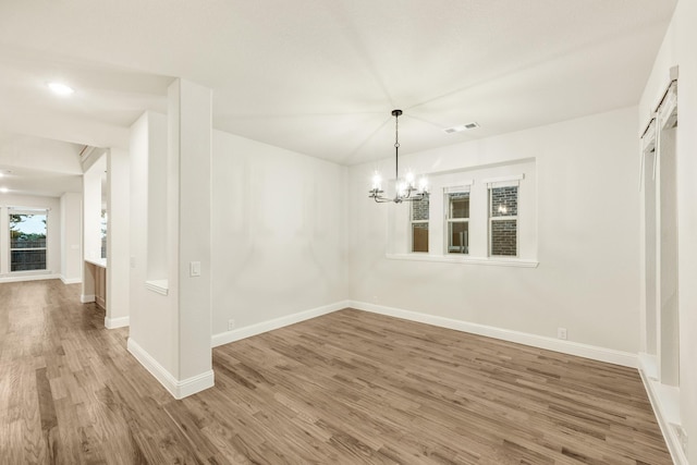1130 Cardinal Dr, Midlothian, TX 76065 - unfurnished dining area with wood finished floors, a chandelier, and baseboards
