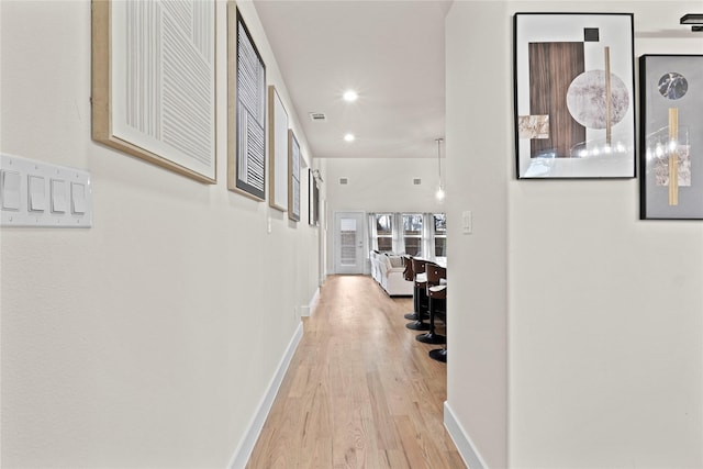 hall with light hardwood / wood-style flooring