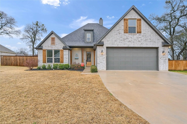 view of front of house with a garage and a front lawn