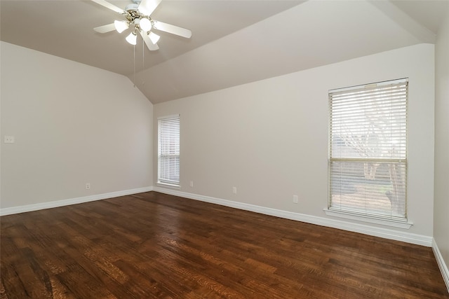 unfurnished room with lofted ceiling, plenty of natural light, dark wood-type flooring, and ceiling fan