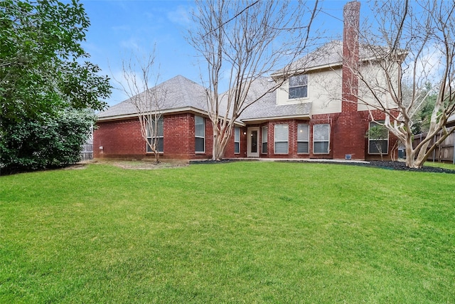 back of property featuring a lawn