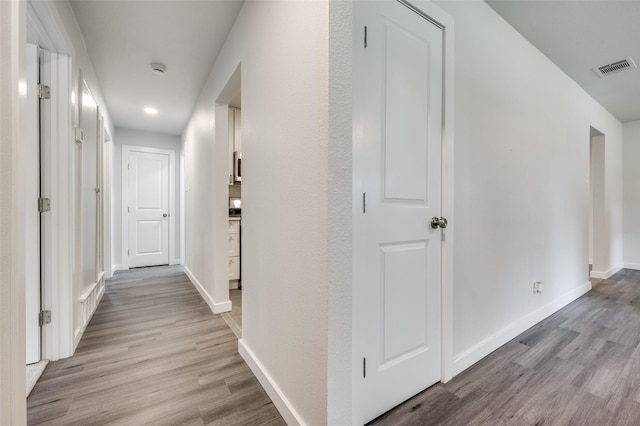 corridor with light hardwood / wood-style flooring