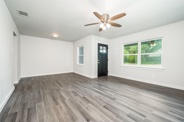 interior space with ceiling fan and dark hardwood / wood-style flooring