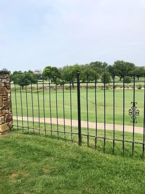 view of gate featuring a lawn