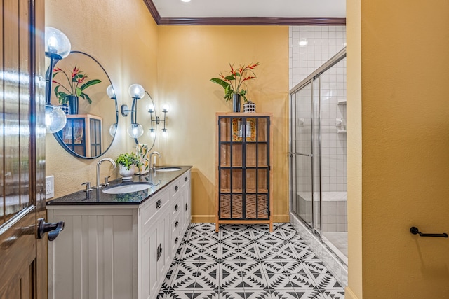 bathroom featuring ornamental molding, vanity, a shower with shower door, and tile patterned floors