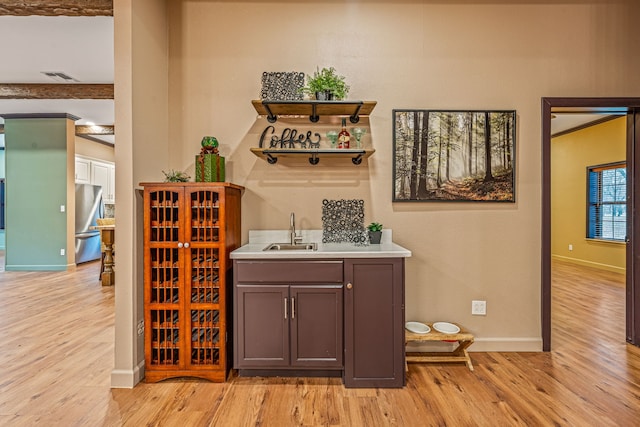 162 Eastledge Dr, Graham, TX 76450 - indoor wet bar with light wood-style floors, baseboards, and freestanding refrigerator