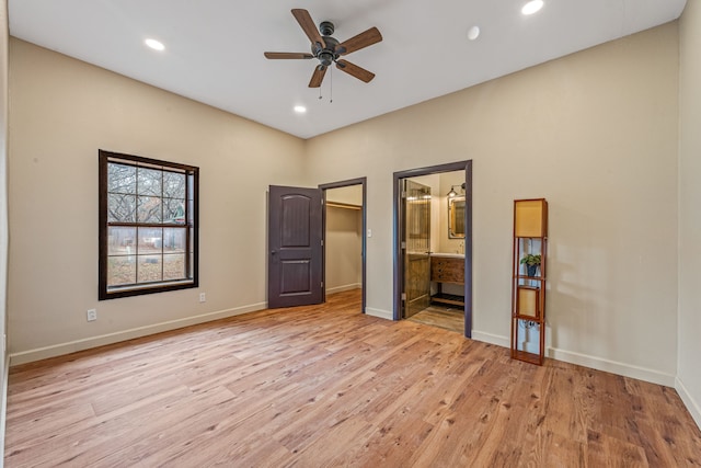 162 Eastledge Dr, Graham, TX 76450 - unfurnished bedroom featuring light wood finished floors, recessed lighting, a spacious closet, baseboards, and connected bathroom