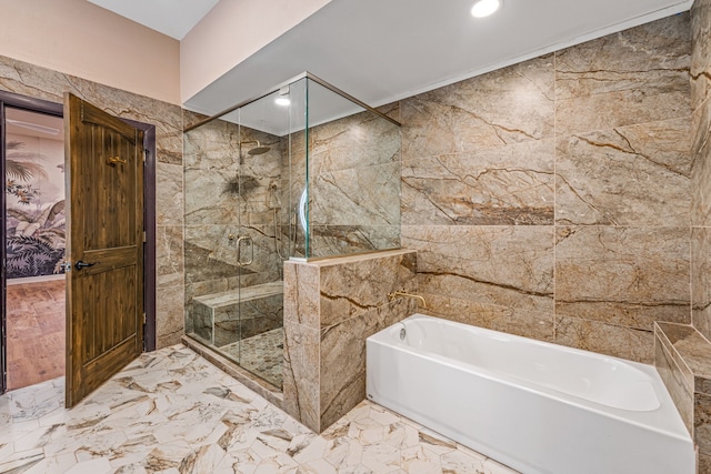 162 Eastledge Dr, Graham, TX 76450 - bathroom featuring a garden tub, a stall shower, tile walls, marble finish flooring, and recessed lighting