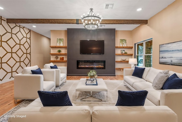 living room with light wood-type flooring, an inviting chandelier, and beam ceiling