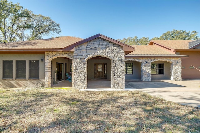 162 Eastledge Dr, Graham, TX 76450 - rear view of property with stone siding and roof with shingles