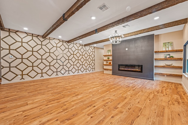 unfurnished living room with light hardwood / wood-style flooring, a chandelier, and beamed ceiling