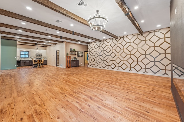 misc room with beam ceiling, light hardwood / wood-style floors, and an inviting chandelier