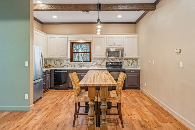 kitchen with white cabinetry, sink, black appliances, and hanging light fixtures