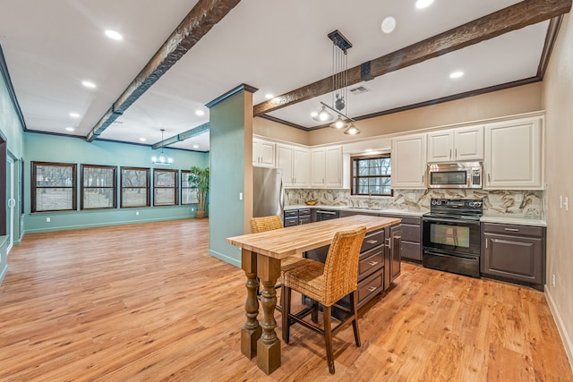 kitchen featuring white cabinetry, stainless steel appliances, decorative light fixtures, beamed ceiling, and wooden counters