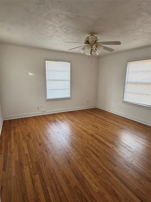 unfurnished room featuring ceiling fan, a textured ceiling, and dark hardwood / wood-style flooring