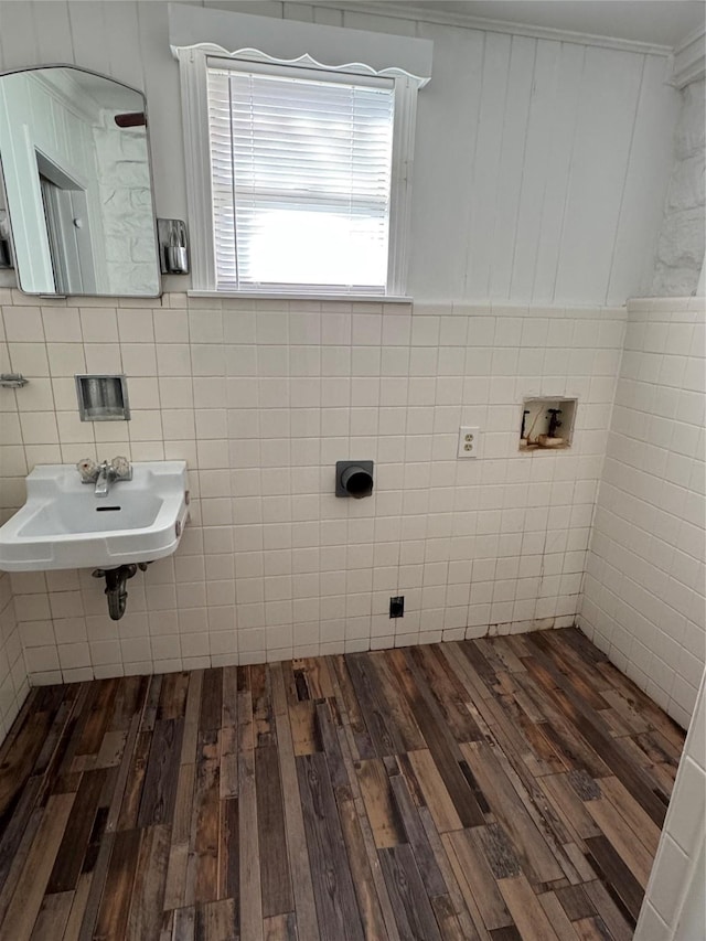 bathroom featuring sink, hardwood / wood-style floors, and tile walls