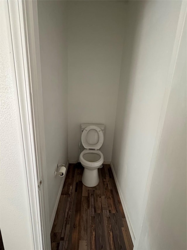 bathroom with wood-type flooring and toilet