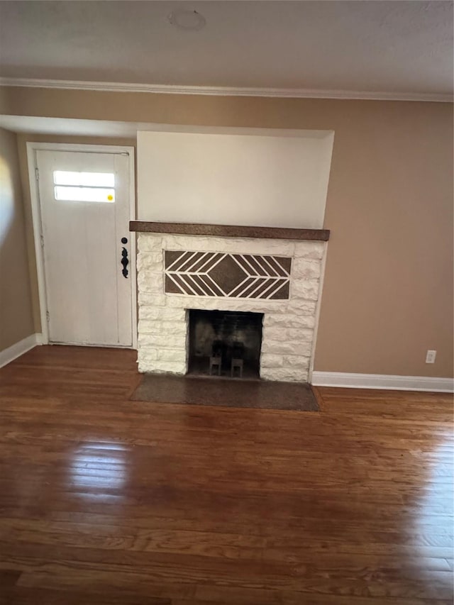 details featuring crown molding, a stone fireplace, and hardwood / wood-style floors