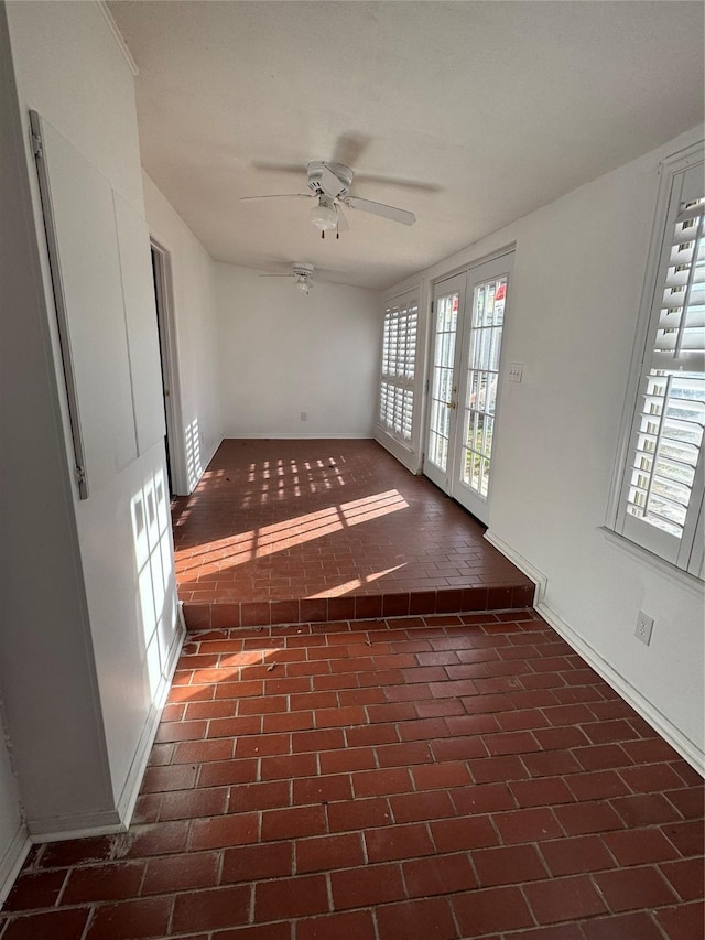 spare room with french doors and ceiling fan