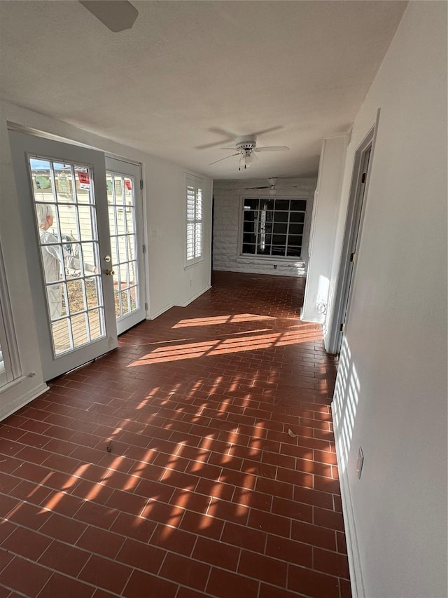 unfurnished living room featuring ceiling fan