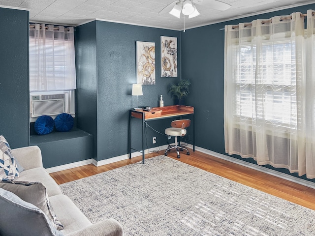 office with ceiling fan, a textured wall, wood finished floors, and baseboards