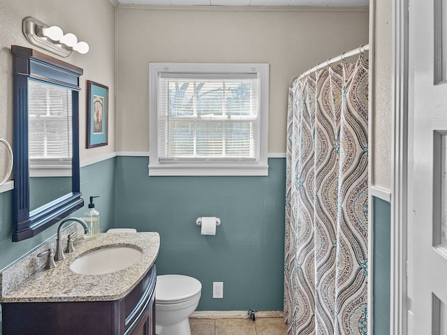 bathroom featuring toilet, tile patterned flooring, and vanity