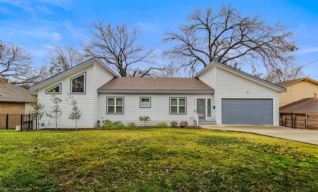 mid-century modern home with a garage, fence, driveway, roof with shingles, and a front yard