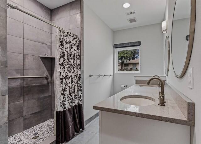 8216 Coolgreene Dr, Dallas, TX 75228 - bathroom with a tile shower, double vanity, and tile patterned flooring