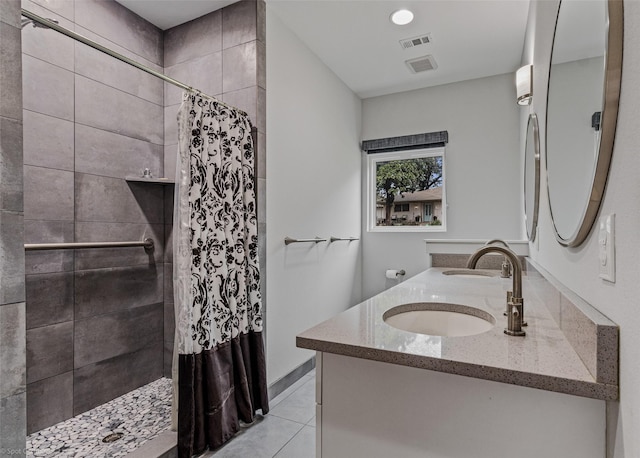 bathroom featuring vanity, tile patterned flooring, and walk in shower