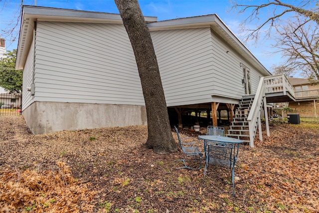 8216 Coolgreene Dr, Dallas, TX 75228 - view of side of property with stairway, a deck, and fence