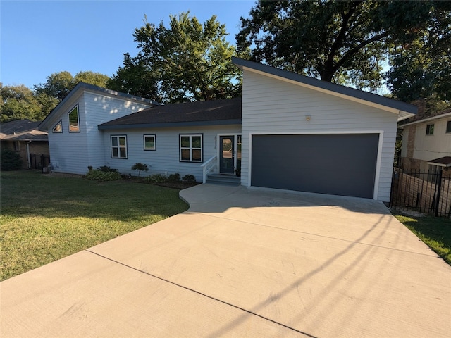 view of front of home featuring a garage and a front yard