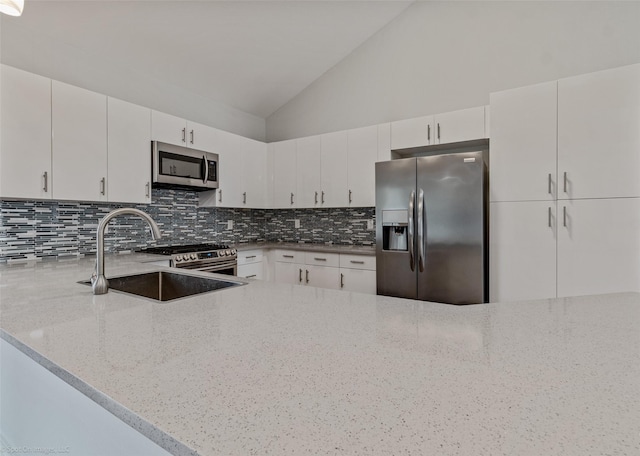 8216 Coolgreene Dr, Dallas, TX 75228 - kitchen featuring stainless steel appliances, a sink, vaulted ceiling, backsplash, and light stone counters