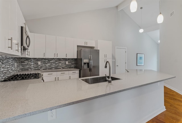 8216 Coolgreene Dr, Dallas, TX 75228 - kitchen featuring stainless steel appliances, a sink, high vaulted ceiling, pendant lighting, and tasteful backsplash