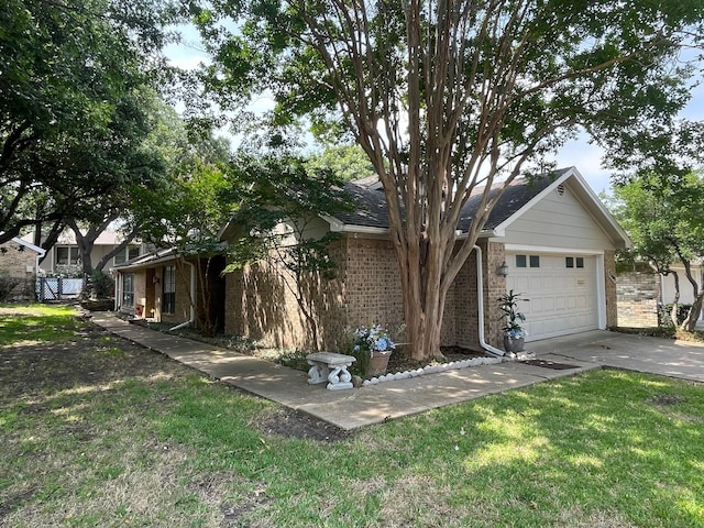 view of front facade with a garage, concrete driveway, brick siding, and a front yard