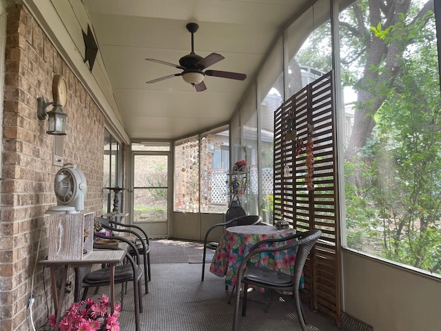 sunroom / solarium featuring ceiling fan