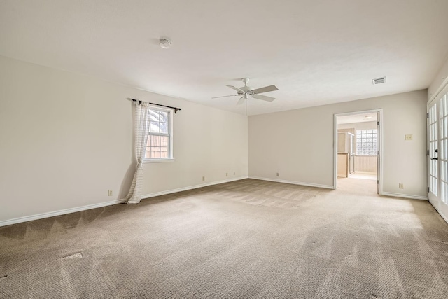 spare room with light carpet and ceiling fan