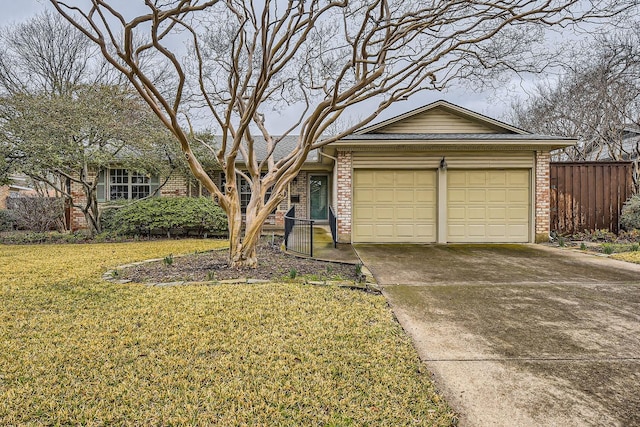 ranch-style home featuring a garage and a front yard