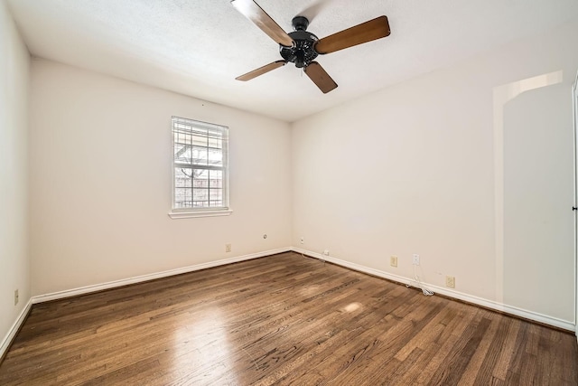 unfurnished room featuring dark wood-type flooring, a textured ceiling, and ceiling fan