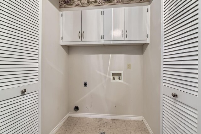 washroom featuring hookup for a washing machine, electric dryer hookup, light tile patterned floors, and cabinets