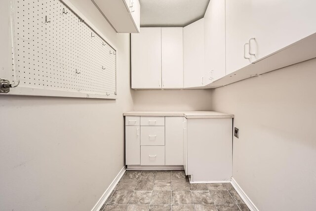 laundry room with cabinets and hookup for an electric dryer