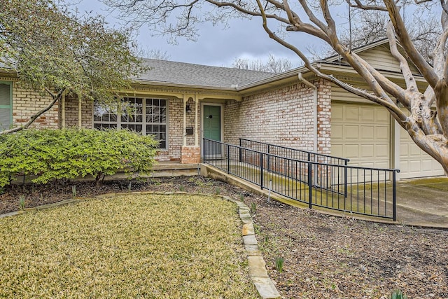 ranch-style home featuring a garage and a front lawn