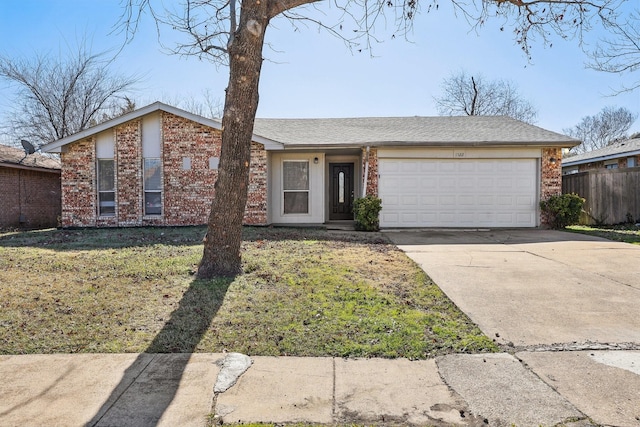 single story home featuring a garage and a front yard