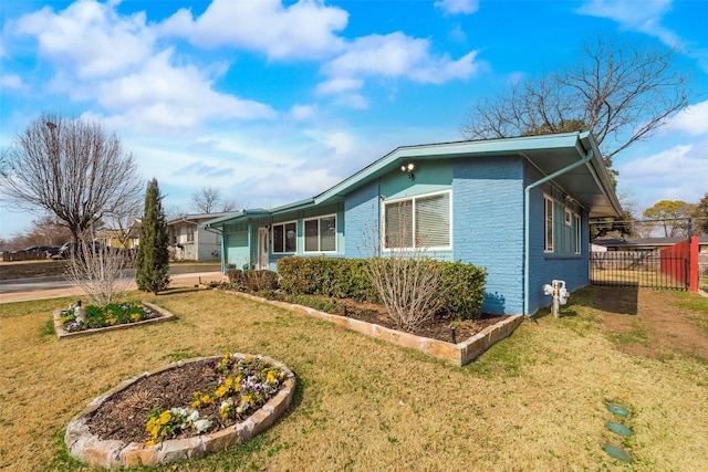 view of side of home with a yard