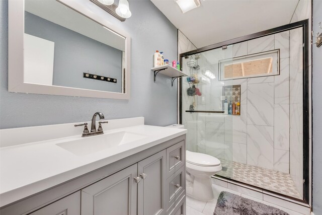 bathroom featuring vanity, toilet, and walk in shower