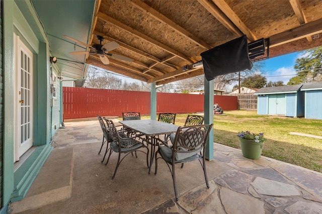 view of patio / terrace featuring a storage shed and ceiling fan