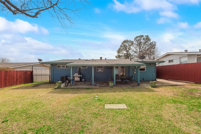 rear view of house featuring a yard and a patio area