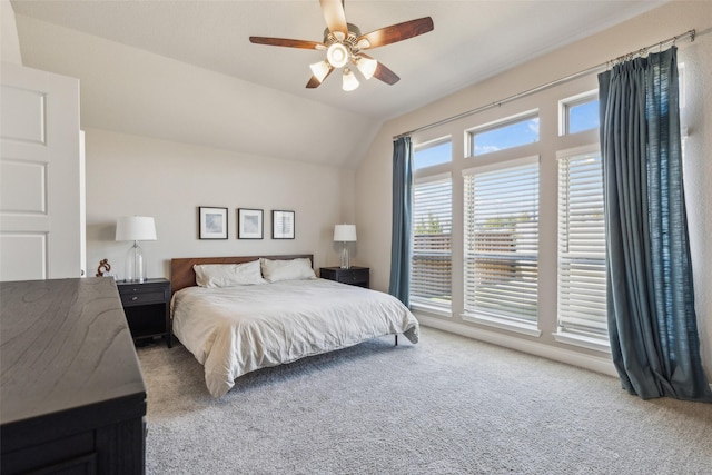 carpeted bedroom featuring vaulted ceiling and ceiling fan